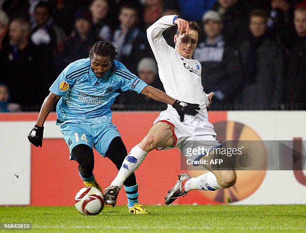 Olympique Marseille Bakari Kone challenges FC Copenhagens Zdenek Pospech during their Europa League round of 32 first leg soccer match in Copenhagen...