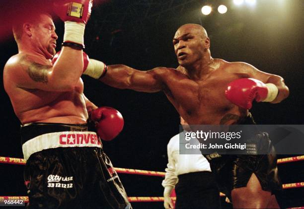 Mike Tyson of the USA lands a punch on opponent Brian Nielsen of Denmark during the world heavyweight fight at the Parken Stadium in Copenhagen,...
