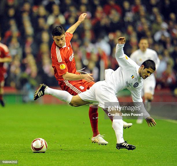 Albert Riera of Liverpool competes with Razvam Paduretu of Unirea Urziceni during the UEFA Europa League first leg game between Liverpool and Unirea...