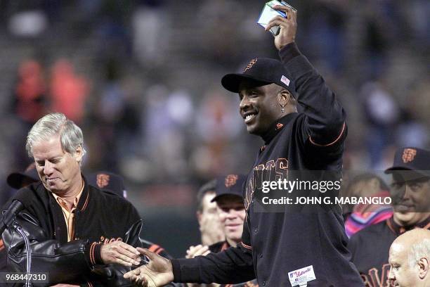 San Francisco Giants slugger Barry Bonds shakes hands with Giants Managing General Partner Peter McGowan after McGowan handed Bonds the 72nd homerun...