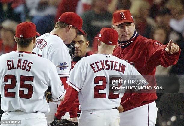 Anaheim Angels manager Mike Scioscia signals the bullpen to replace starting pitcher Kevin Appier during a pause in play against the San Francisco...