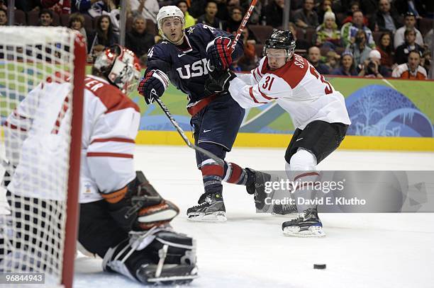Winter Olympics: USA Ryan Callahan in action vs Switzerland Mathias Seger during Men's Preliminary Round - Group A Game 1 at Canada Hockey Place....