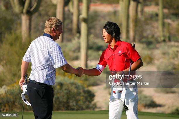 Ross McGowan of England congratulates Ryo Ishikawa of Japan on the 18th hole during round two of the Accenture Match Play Championship at the...