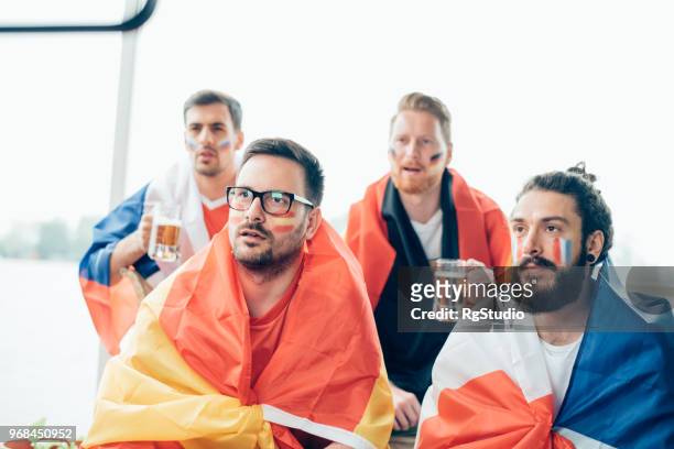 spanish national soccer team supporter watching game with friends - france national soccer team stock pictures, royalty-free photos & images