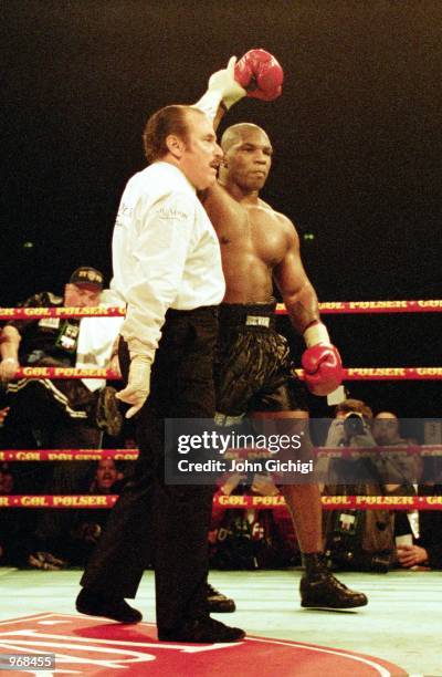 The referee holds aloft Mike Tyson of the USA arm as he is declared the winner of the World Heavyweight fight against Brian Nielsen of Denmark held...