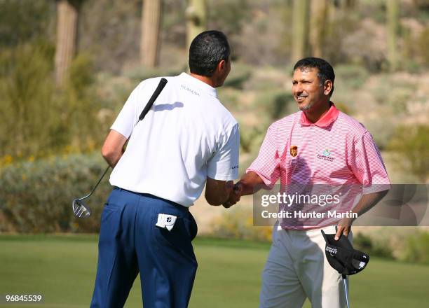 Matt Kuchar congratulates Jeev Milkha Singh of India on the 18th hole during round two of the Accenture Match Play Championship at the Ritz-Carlton...