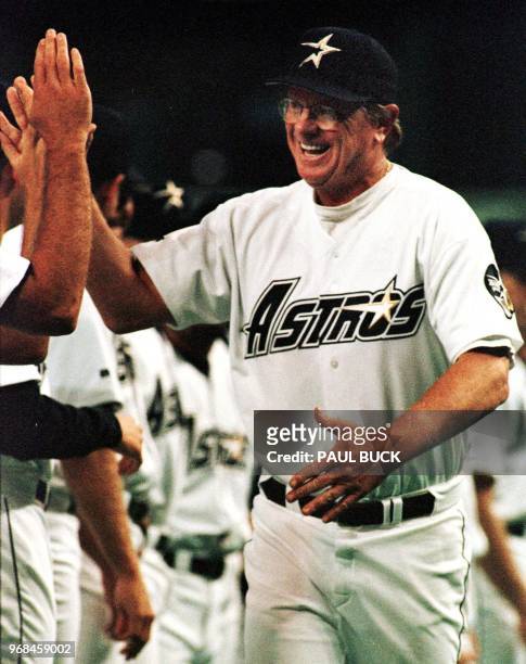 In this 06 April 1999 file photo, Houston Astros manager Larry Dierker high-fives teammates during player introductions on opening day at the...