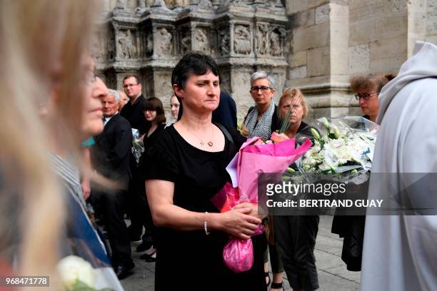 Mother of murdered French au-pair Sophie Lionnet, Catherine Devallonne holds flowers as she leaves the church after Sophie's funeral in Sens on June...