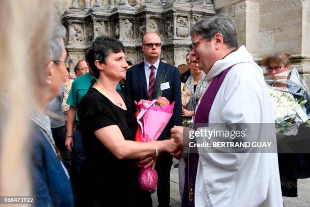 Mother of murdered French au-pair Sophie Lionnet, Catherine Devallonne is comforted by the priest as she leaves the church after Sophie's funeral in...