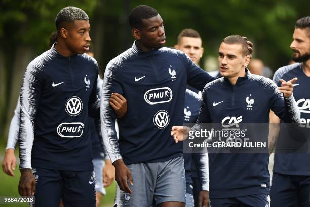 France's defender Presnel Kimpembe, midfielder Paul Pogba and foward Antoine Griezmann arrive for a training session at the French national football...