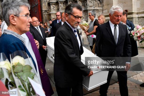 Pallbearers carry the coffin of murdered French au-pair Sophie Lionnet as they leave the church after Sophie's funeral in Sens on June 6, 2018. - A...