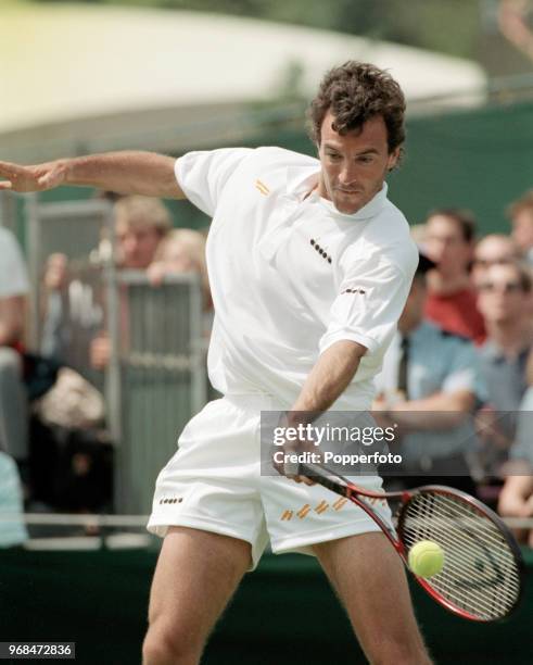 Javier Frana of Argentina returns the ball against Chris Bailey of Great Britain during the Mens Singles first round on day two of the 1994 Wimbledon...