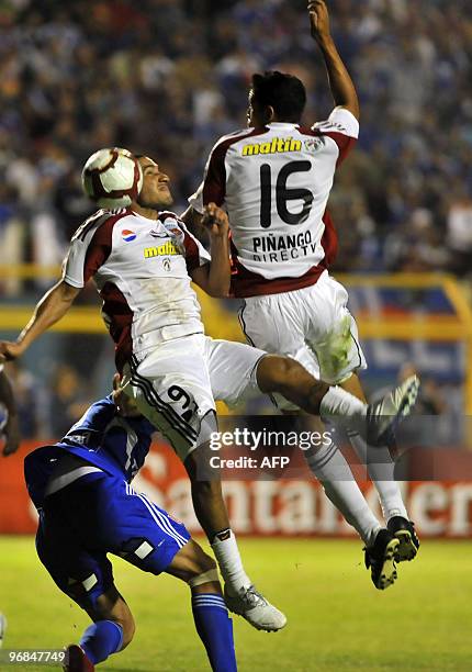 Footballers Rafael Castellin and Bremer Pinango of Venezuela's Caracas, vie with Edson Puch of Chile's Universidad de Chile, during a Copa...
