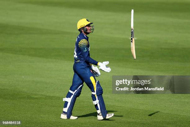 Connor Brown of Glamorgan throws his bat in the air after being dismissed on 98 caught by Jason Roy of Surrey off the bowling of Rikki Clarke of...