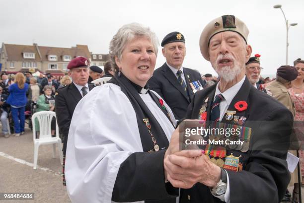 Normandy veteran Lewis Trinder who was in the Royal navy dances with Reverend Mandy Reynolds as guests sing Auld Lang Syne at the Arromanches...