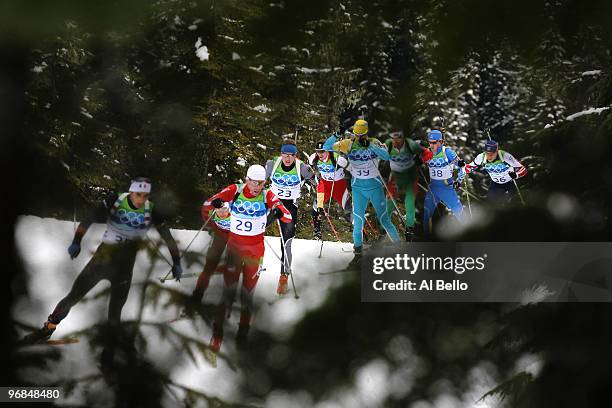 Tomasz Sikora of Poland competes with fellow biathletes during the Men's Biathlon 12.5km Pursuit on day 5 of the 2010 Vancouver Winter Olympics at...