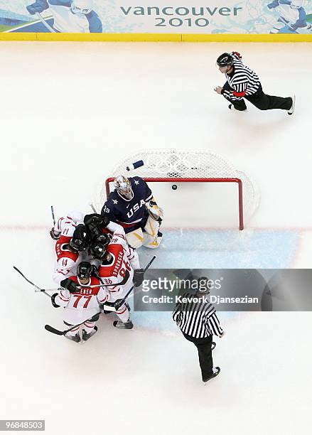 Roman Wick of Switzerland celebrates with teammates after he scored a goal in the third period against goalie Ryan Miller of the United States during...