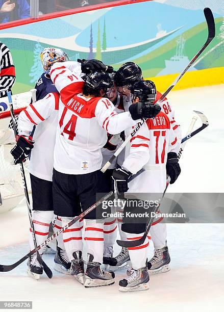 Roman Wick of Switzerland celebrates with teammates after he scored a goal in the third period during the ice hockey men's preliminary game between...