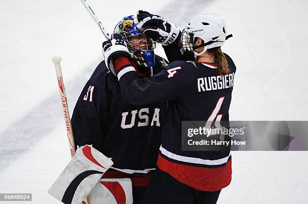 Jessie Vetter of the United States celebrates with Angela Ruggiero of the United States after they won the ice hockey women's preliminary game...