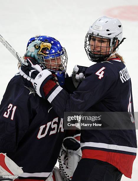 Jessie Vetter of the United States celebrates with Angela Ruggiero of the United States after they won the ice hockey women's preliminary game...