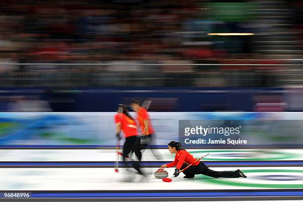 Third Yin Liu of China delivers as Qingshuang Yue and Yan Zhou sweep during the women's curling round robin game against Denmark on day 7 of the...