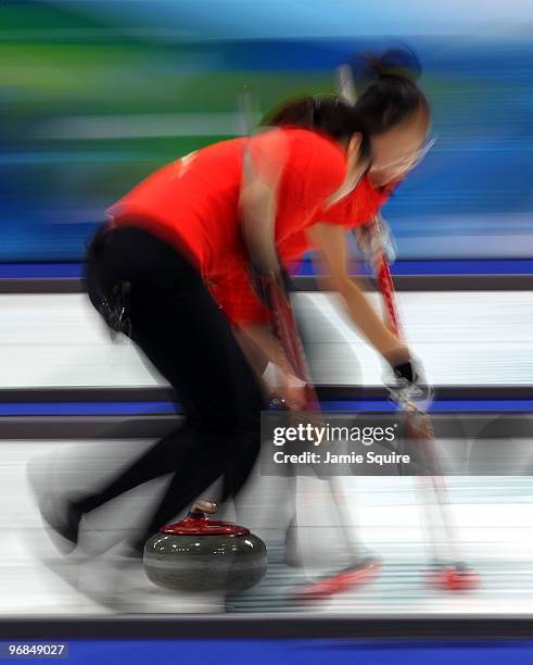 Members of the Chinese team compete during the women's curling round robin game against Japan on day 7 of the Vancouver 2010 Winter Olympics at...