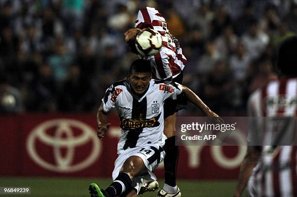 Jose Sosa of Argentina's Estudiantes de La Plata, and Carlos Solis of Peru's Alianza Lima, jump for a header during a Libertadores Cup football match...