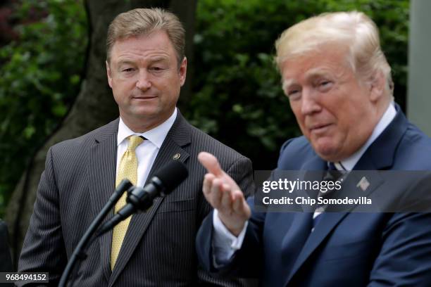 Sen. Dean Heller listens to U.S. President Donald Trump delivers remarks during a signing ceremony for the Veterans Affairs Mission Act in the Rose...