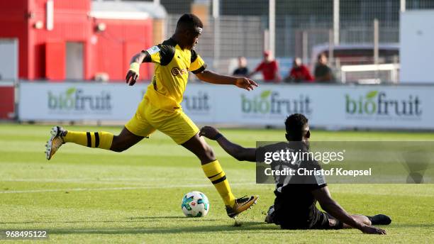 Kevin Bukusu of Leverkusen blocks a shot of Youssoufa Moukoko of Dortmund during the B Juniors German Championship Semi Final first leg match match...