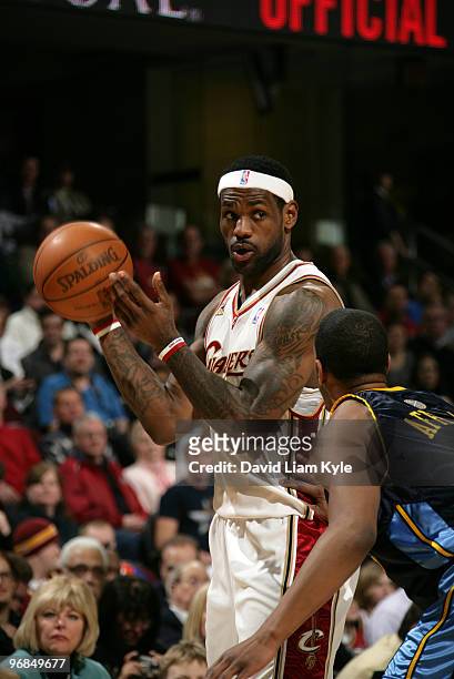 LeBron James of the Cleveland Cavaliers looks for an open teammate defended by Arron Afflalo of the Denver Nuggets on February 18, 2010 at The...