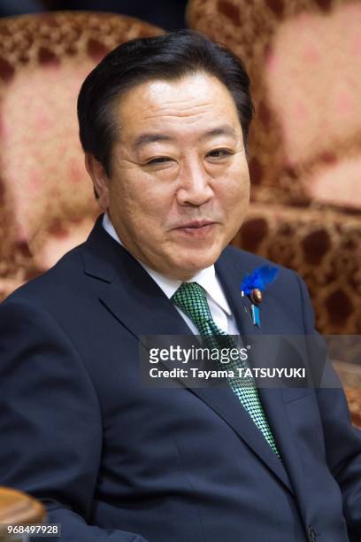 Japanese Prime Minister Yoshihiko Noda smiles as he listens to opposition lawmaker's questions on July 19, 2012 during an upper house special...
