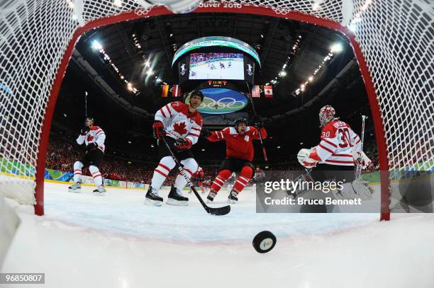 Scott Niedermayer and Martin Brodeur of Canada look on as Switzerland scores goalduring the ice hockey men's preliminary game between Switzerland and...