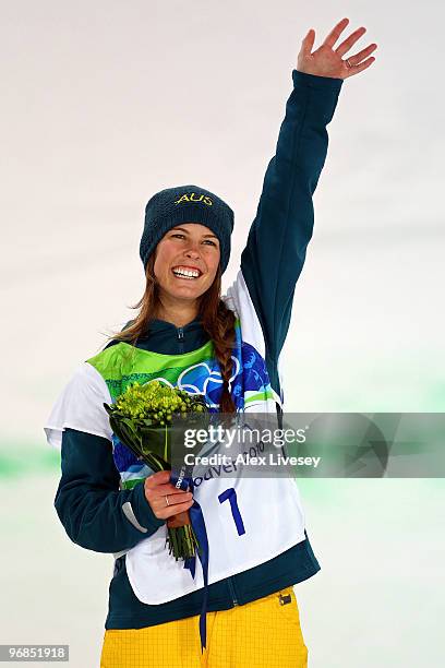 Torah Bright of Australia celebrates winning the gold medal during the flower ceremony for the Snowboard Women's Halfpipe final on day seven of the...