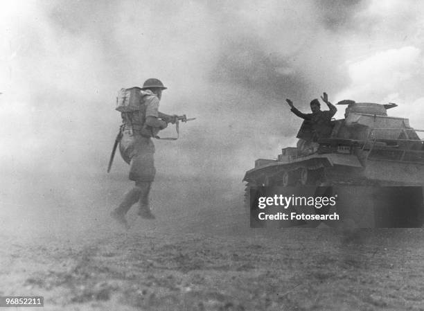 Photograph of a Member of a German Tank Crew Surrendering as British Infantry Rush His Tank in El Alamein, October 27th, 1942.