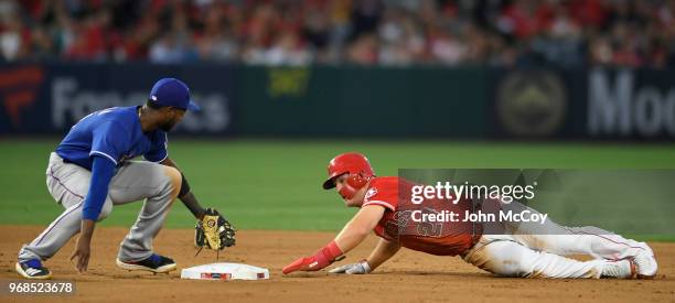 Mike Trout of the Los Angeles Angels of Anaheim overslides second base but Jurickson Profar of the Texas Rangers can not make the tag in the sixth...