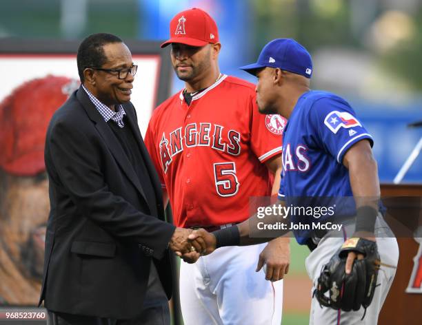 Hall of Famer Rod Carew, Albert Pujols of the Los Angeles Angels of Anaheim and Adrian Beltre of the Texas Rangers share a moment after a ceremony...