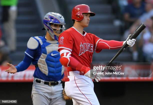 Shohei Ohtani of the Los Angeles Angels of Anaheim at bat while Robinson Chirinos of the Texas Rangers asks for a ball in the second inning at Angel...