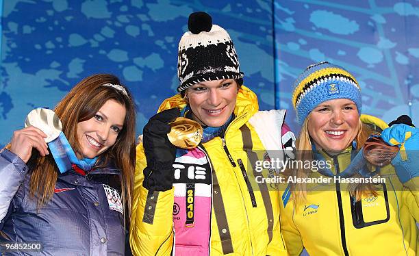 Julia Mancuso of the United States, Silver, Maria Riesch of Germany, Gold and Anja Paerson of Sweden, Bronze, celebrate during the medal ceremony for...