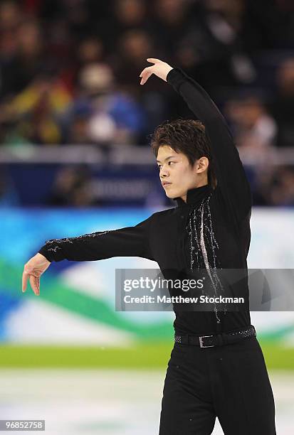 Takahiko Kozuka of Japan competes in the men's figure skating free skating on day 7 of the Vancouver 2010 Winter Olympics at the Pacific Coliseum on...