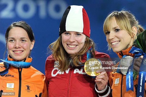 Annette Gerritsen of Netherlands celebrates winning Silver, Christine Nesbitt of Canada Gold, and Laurine Van Riessen of Netherlands Bronze during...