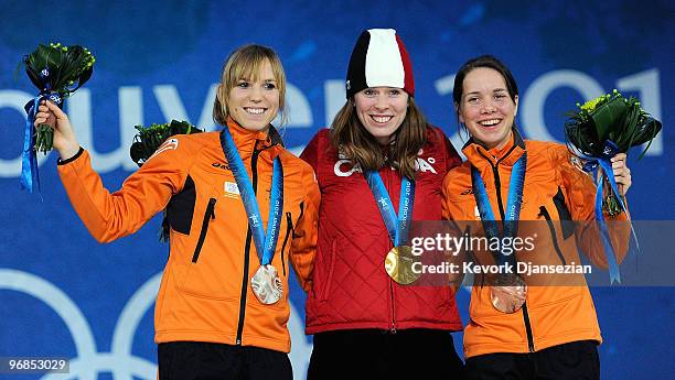 Annette Gerritsen of Netherlands celebrates winning Silver, Christine Nesbitt of Canada Gold, and Laurine Van Riessen of Netherlands Bronze during...