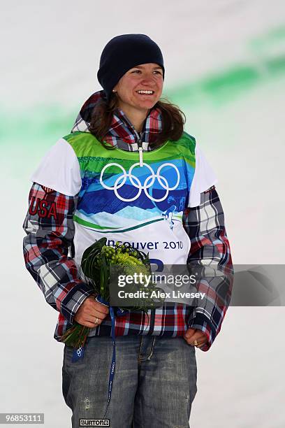 Kelly Clark of the United States celebrates winning the bronze medal during the flower ceremony for the Snowboard Women's Halfpipe final on day seven...