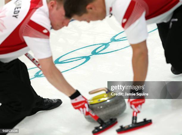 Detail of the Olympic rings as Swiss team members sweep during the curling round robin game against Norway on day 7 of the Vancouver 2010 Winter...