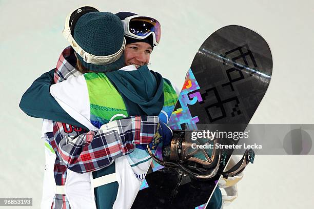 Kelly Clark of the United States embraces Torah Bright of Australia after Bright won the gold medal and Clark won bronze in the Snowboard Women's...