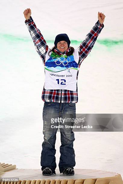 Kelly Clark of the United States celebrates winning the bronze medal during the flower ceremony for the Snowboard Women's Halfpipe final on day seven...