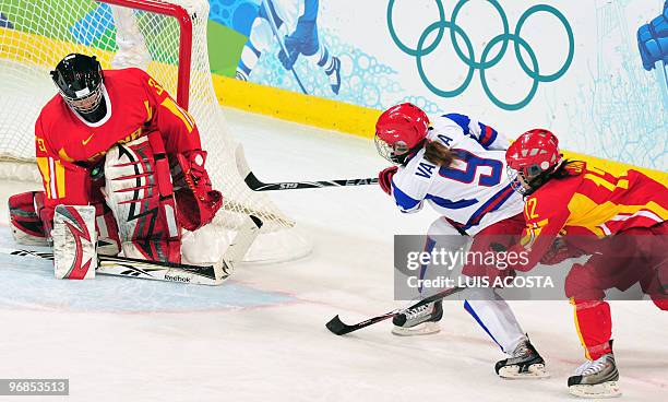 Cina's goal keeper Yao Shi stops the puck during the Women's Ice Hockey preliminary game between China against Russia at the UBC Thunderbird Arena...