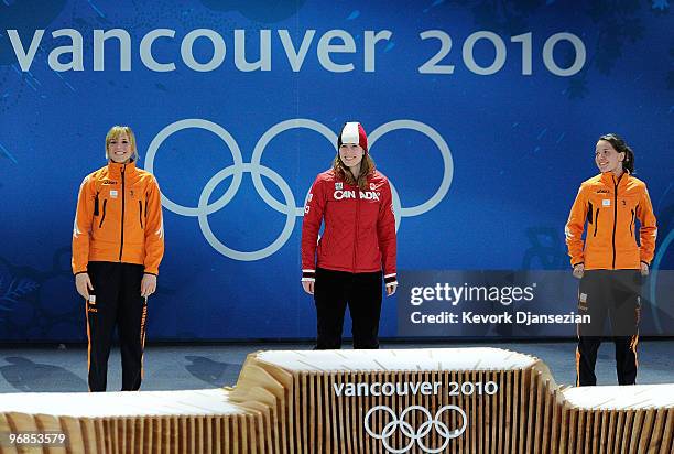 Annette Gerritsen of Netherlands celebrates winning Silver, Christine Nesbitt of Canada Gold, and Laurine Van Riessen of Netherlands Bronze during...