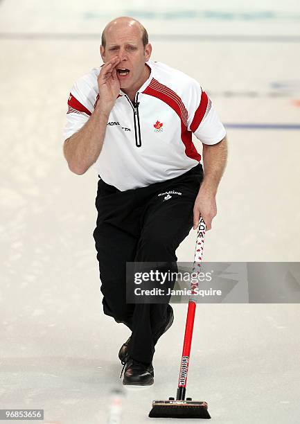 Skip Kevin Martin of Canada calls to sweepers Marc Kennedy and Ben Hebert to hurry during the curling round robin game against France on day 7 of the...