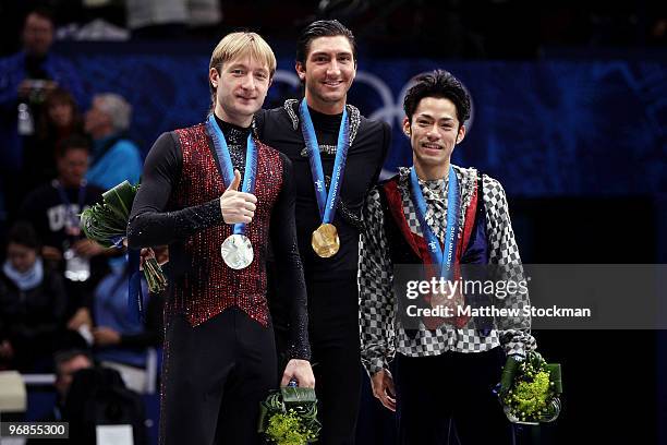 Gold medalist Evan Lysacek of the United States poses with silver medalist Evgeni Plushenko of Russia and bronze medalist Daisuke Takahashi of Japan...