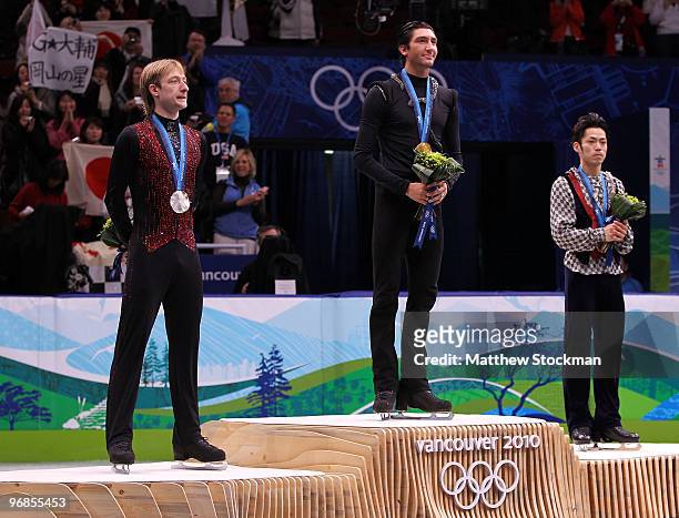 Gold medalist Evan Lysacek of the United States poses with silver medalist Evgeni Plushenko of Russia and bronze medalist Daisuke Takahashi of Japan...